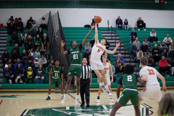 Ayo goes for the jump ball at the start of the Winslow v. Cherokee game.